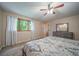 Spacious main bedroom featuring soft natural light, neutral color palette, and overhead ceiling fan at 2276 S Dover Way, Lakewood, CO 80227