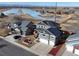 Stunning aerial view of gray homes with solar panels near a scenic lake, offering a blend of modern living and natural beauty at 5895 E Conservation Dr, Frederick, CO 80504