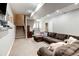 Finished basement featuring plush carpeting, a large sectional sofa, and recessed lighting at 5895 E Conservation Dr, Frederick, CO 80504