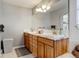 Bright bathroom featuring dual sinks, modern lighting, and a large mirror at 5895 E Conservation Dr, Frederick, CO 80504