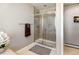 Bathroom featuring tiled shower with sliding glass doors and modern fixtures at 5895 E Conservation Dr, Frederick, CO 80504