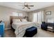 Bedroom features a bed, desk, ceiling fan and many windows allowing for plenty of natural light at 5895 E Conservation Dr, Frederick, CO 80504