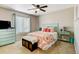 Cozy bedroom features a bed, dresser, ceiling fan, and window letting in natural light at 5895 E Conservation Dr, Frederick, CO 80504