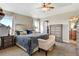Well-lit bedroom featuring a large bed, ceiling fan, nightstands, and tasteful decor at 5895 E Conservation Dr, Frederick, CO 80504
