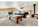 Entertainment space includes a billiard table, comfortable sofa, and additional seating at 5895 E Conservation Dr, Frederick, CO 80504