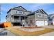 Exterior view of a charming two-story house with gray siding and a well-maintained front yard at 5895 E Conservation Dr, Frederick, CO 80504