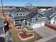 Two-story home with gray siding, solar panels, two-car garage, and a landscaped front yard with a heart-shaped flower bed at 5895 E Conservation Dr, Frederick, CO 80504