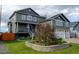 Beautiful two-story home featuring a well-manicured lawn and stone accents at 5895 E Conservation Dr, Frederick, CO 80504