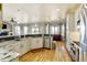 Bright and spacious kitchen with white cabinets, granite countertops, and an open layout at 5895 E Conservation Dr, Frederick, CO 80504