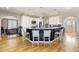 Open kitchen featuring a large island with bar seating, white cabinets, and stainless steel appliances at 5895 E Conservation Dr, Frederick, CO 80504
