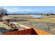 Breathtaking view of the natural wetlands area behind the property with lake at 5895 E Conservation Dr, Frederick, CO 80504