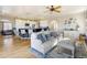 Spacious living room offering an open layout and hardwood floors, connecting to a modern kitchen at 5895 E Conservation Dr, Frederick, CO 80504