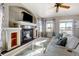 Cozy living room featuring a fireplace, television, and natural light from large windows at 5895 E Conservation Dr, Frederick, CO 80504