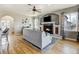 Comfortable living room area with a fireplace, large windows, and hardwood floors at 5895 E Conservation Dr, Frederick, CO 80504