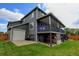 Two-story home with covered deck, spacious yard, and lower level storage at 5895 E Conservation Dr, Frederick, CO 80504