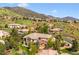 Luxury home showcasing mountain views and a private balcony surrounded by lush landscaping at 16442 Rocky Point Ln, Morrison, CO 80465
