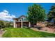 Lovely backyard featuring a lush lawn and mature trees providing shade and privacy to enjoy the outdoor living space at 16442 Rocky Point Ln, Morrison, CO 80465