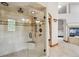 Elegant tiled shower features a glass door, built-in bench, and multiple shower heads at 16442 Rocky Point Ln, Morrison, CO 80465