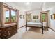 Comfortable bedroom with large window views and a four-poster bed creates an inviting space at 16442 Rocky Point Ln, Morrison, CO 80465