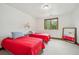 Cozy bedroom with two beds, a bright window with exterior views, and soft carpet at 16442 Rocky Point Ln, Morrison, CO 80465