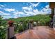 Large wooden deck with scenic views of the surrounding hillside and neighborhood at 16442 Rocky Point Ln, Morrison, CO 80465