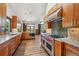Modern kitchen featuring stainless steel appliances, granite countertops, and wood cabinets and flooring at 16442 Rocky Point Ln, Morrison, CO 80465