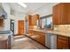 Well-lit kitchen equipped with stainless steel appliances, wood cabinets, and a window over the sink at 16442 Rocky Point Ln, Morrison, CO 80465