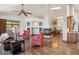 Spacious living room featuring hardwood floors, a stone fireplace, and an open layout to the kitchen and dining area at 16442 Rocky Point Ln, Morrison, CO 80465