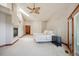 Open main bedroom features a fireplace, a ceiling fan, an exterior access door, and lots of natural light at 16442 Rocky Point Ln, Morrison, CO 80465