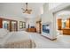 Spacious main bedroom features vaulted ceilings, fireplace, exterior access, and an open entrance to a luxurious bathroom at 16442 Rocky Point Ln, Morrison, CO 80465
