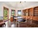 Bright office with hardwood floors, built-in bookshelves, and large windows offering natural light and views at 16442 Rocky Point Ln, Morrison, CO 80465