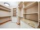 Large walk-in closet has custom shelving, drawers, and plenty of hanging space for organization at 16442 Rocky Point Ln, Morrison, CO 80465