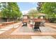 Relaxing backyard with a fire pit, Adirondack chairs, raised garden beds and brick patio at 958 S Columbine St, Denver, CO 80209