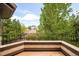 Balcony with metal railing offering a view of the lush green trees and neighborhood at 958 S Columbine St, Denver, CO 80209
