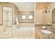 Luxurious bathroom with soaking tub, glass enclosed shower, vanity, and elegant chandelier at 958 S Columbine St, Denver, CO 80209