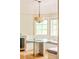 Sunlit breakfast nook with hardwood floors, a unique table with bay window and bench seating at 958 S Columbine St, Denver, CO 80209