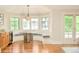 Bright breakfast nook area featuring hardwood flooring, a large bay window and a table with seating at 958 S Columbine St, Denver, CO 80209