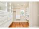 Walk-in closet with custom shelving, drawers, wood floor, and a window for natural light at 958 S Columbine St, Denver, CO 80209