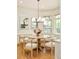 Sunlit dining area with modern chandelier, round table, and views of the outdoor landscape at 958 S Columbine St, Denver, CO 80209