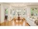 Bright dining room with bay windows, hardwood floors, a chandelier, and light colored furnishings at 958 S Columbine St, Denver, CO 80209