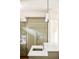 Close up of the kitchen island featuring a stainless steel sink and faucet, and the light green cabinets and refrigerator at 958 S Columbine St, Denver, CO 80209