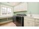 Laundry room featuring front load washer and dryer, utility sink, white cabinetry, and a window at 958 S Columbine St, Denver, CO 80209