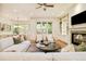 Living room featuring a fireplace, large windows, neutral furnishings, and view into the dining area at 958 S Columbine St, Denver, CO 80209