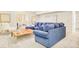 Stylish living room with a comfortable blue sectional sofa and bright decor at 958 S Columbine St, Denver, CO 80209