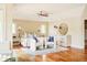 Bright bedroom suite featuring hardwood flooring, large windows, sitting area and a ceiling fan at 958 S Columbine St, Denver, CO 80209