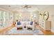 Inviting bedroom with large windows, ceiling fan, hardwood floors, and stylish decor at 958 S Columbine St, Denver, CO 80209