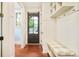 Practical mud room with brick floors, storage, and seating, providing a functional entryway at 958 S Columbine St, Denver, CO 80209