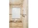 Shower featuring multi-head shower fixture, tile walls, marble seat, and glass block window at 958 S Columbine St, Denver, CO 80209