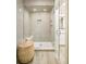 Modern shower showcasing gray subway tile, glass door, seat, and built-in niche at 958 S Columbine St, Denver, CO 80209