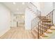 Elegant staircase with wood treads, carpet runner, and wrought iron railing at 958 S Columbine St, Denver, CO 80209